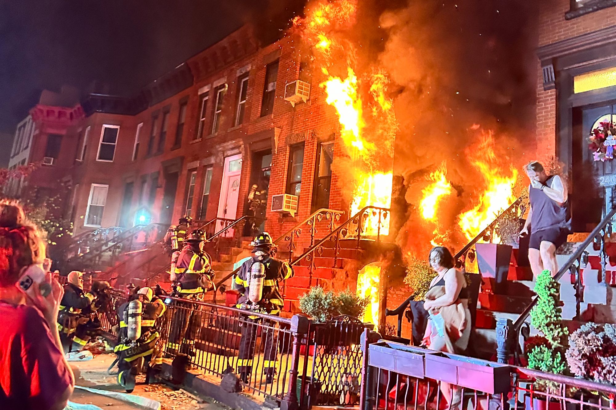 Flames coming out of a building in Crown Heights, Brooklyn on Nov. 12, 2023 after a fire was sparked by a lithium-ion battery from an electric scooter.
