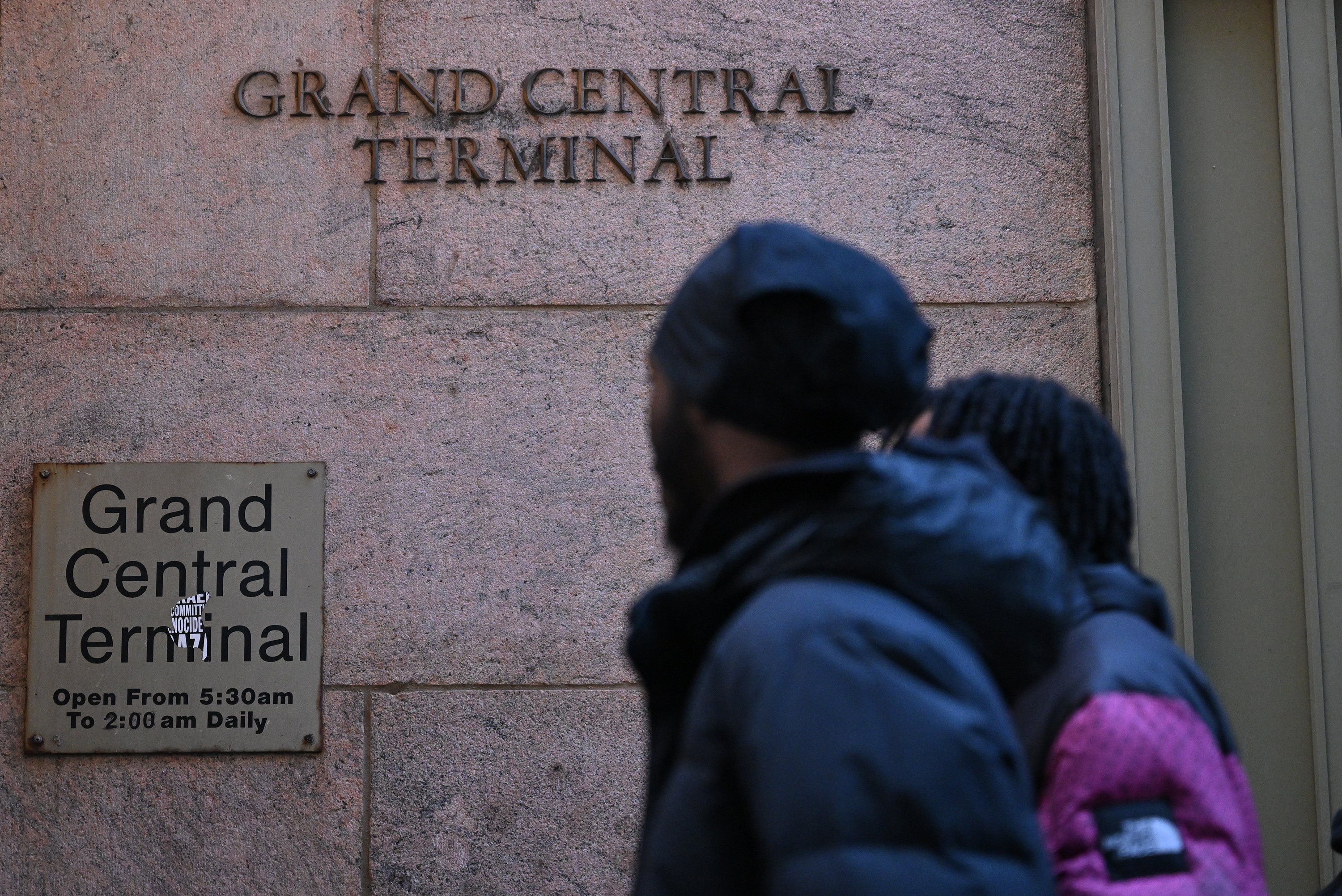 Man in front of Grand Central Terminal sign