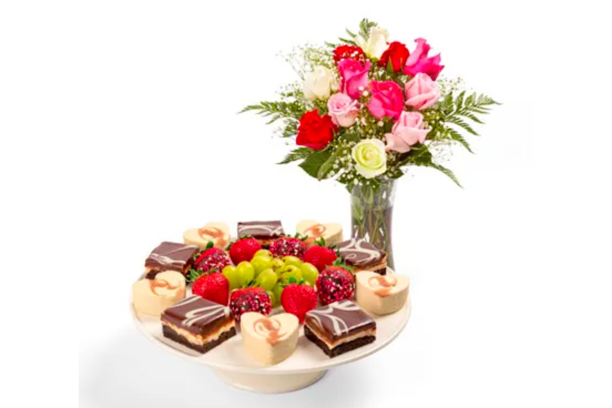 A dessert platter and roses in a vase.
