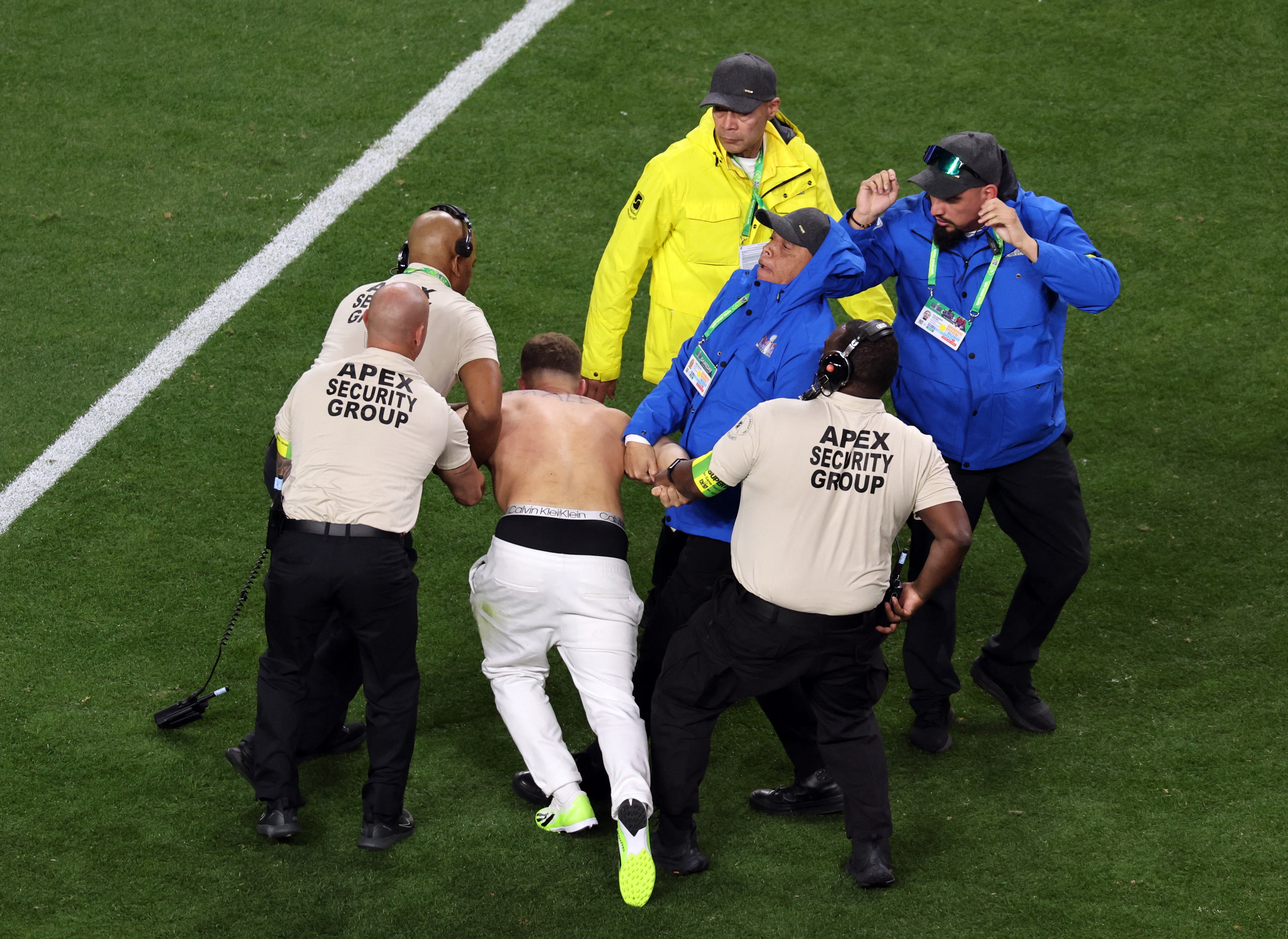 A streaker is corralled by security during Super Bowl 2024. 