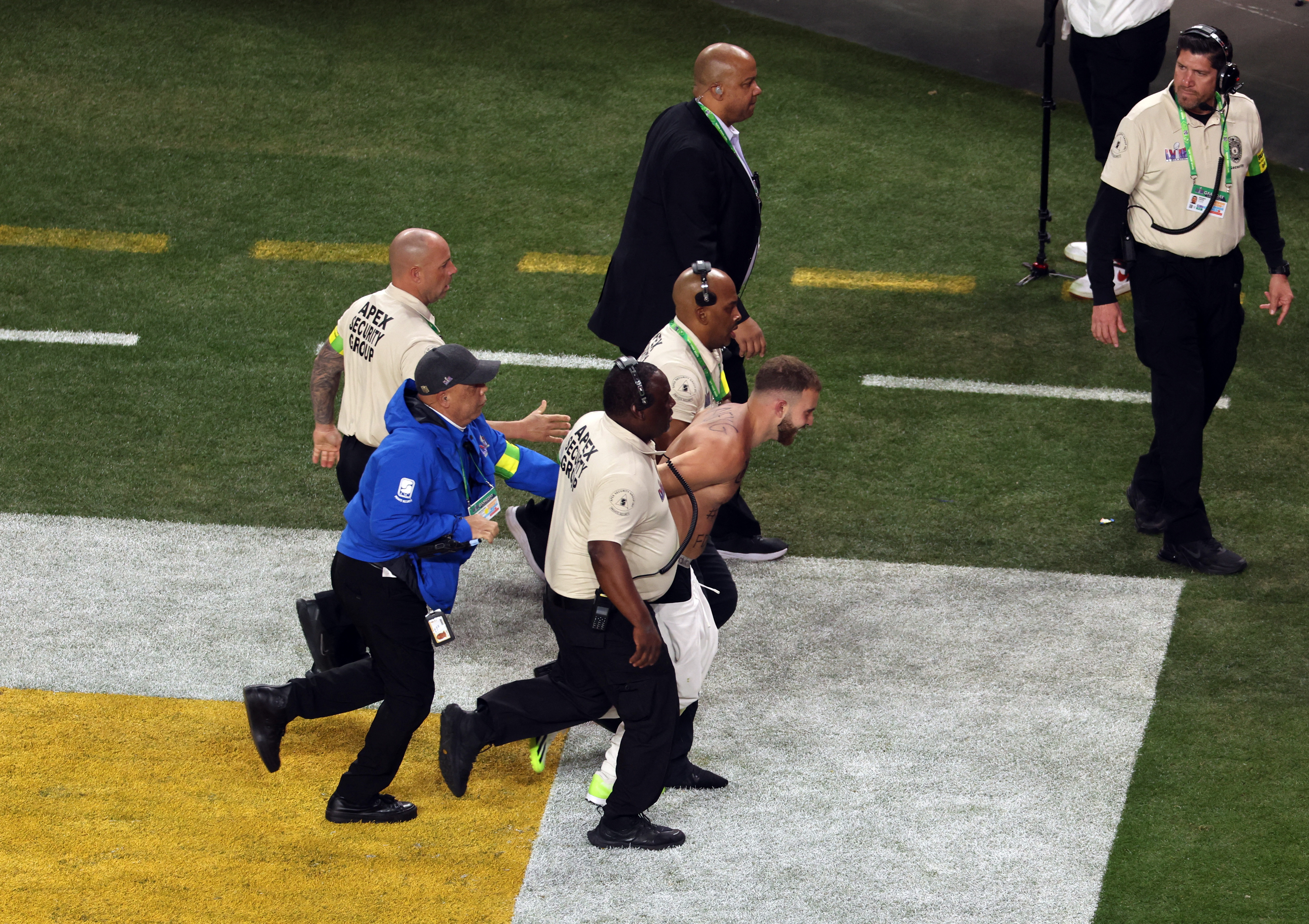 A streaker is corralled by security during Super Bowl 2024.
