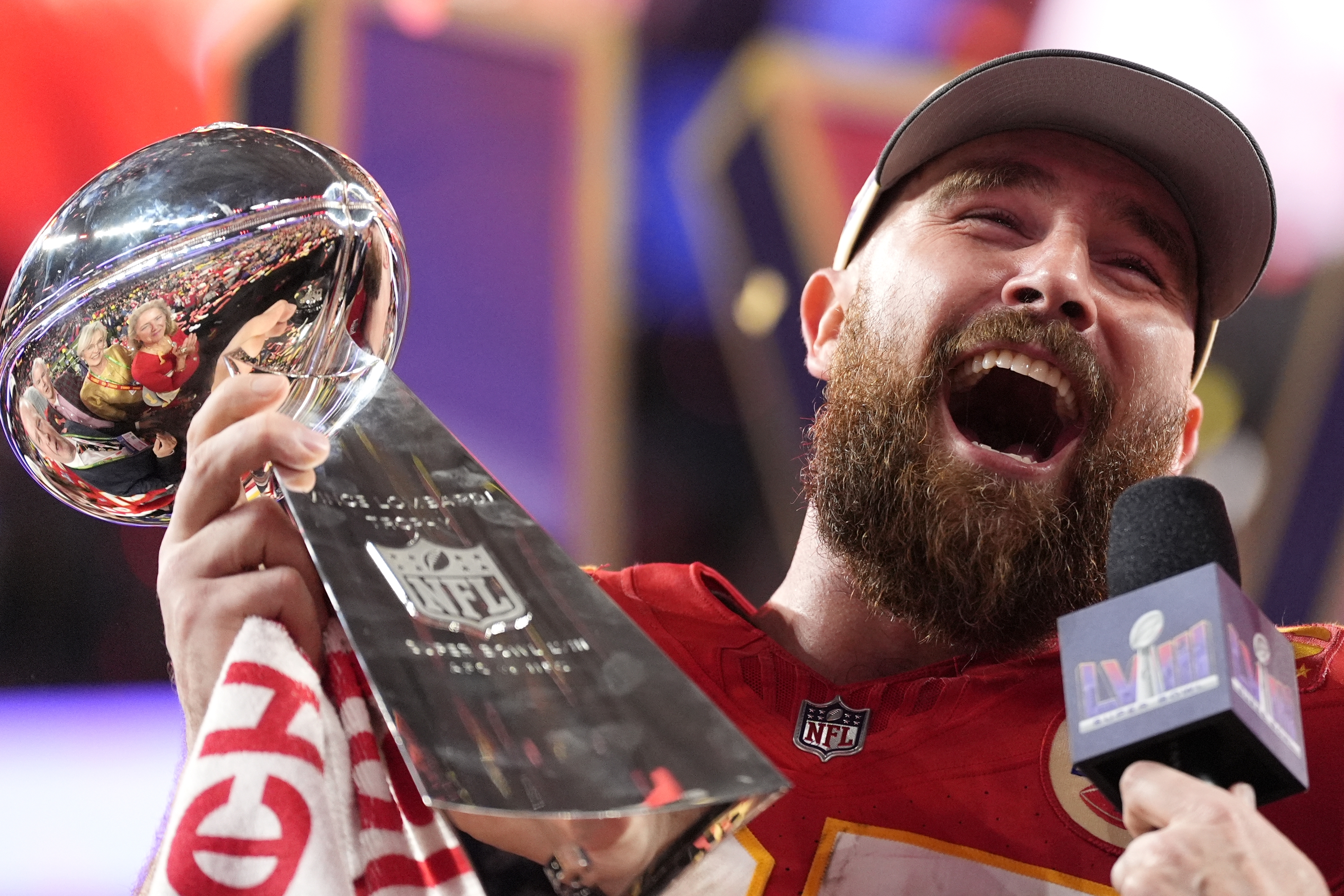 Travis Kelce holds the Lombardi Trophy after the Chiefs' Super Bowl 2024 win.