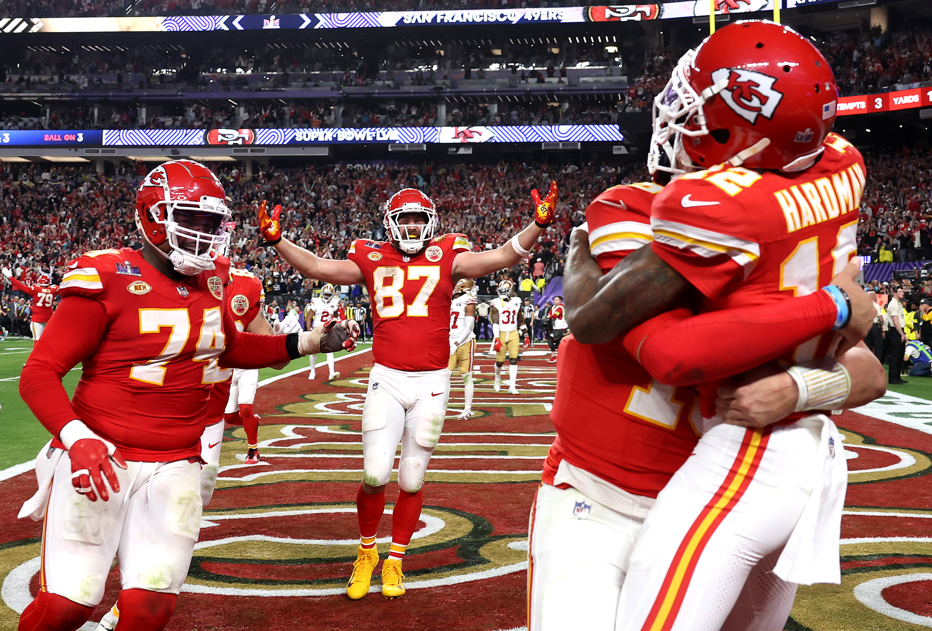Mecole Hardman Jr. #12 of the Kansas City Chiefs celebrates with teammates after scoring game-winning touchdown against San Francisco 49ers during Super Bowl LVIII at Allegiant Stadium.