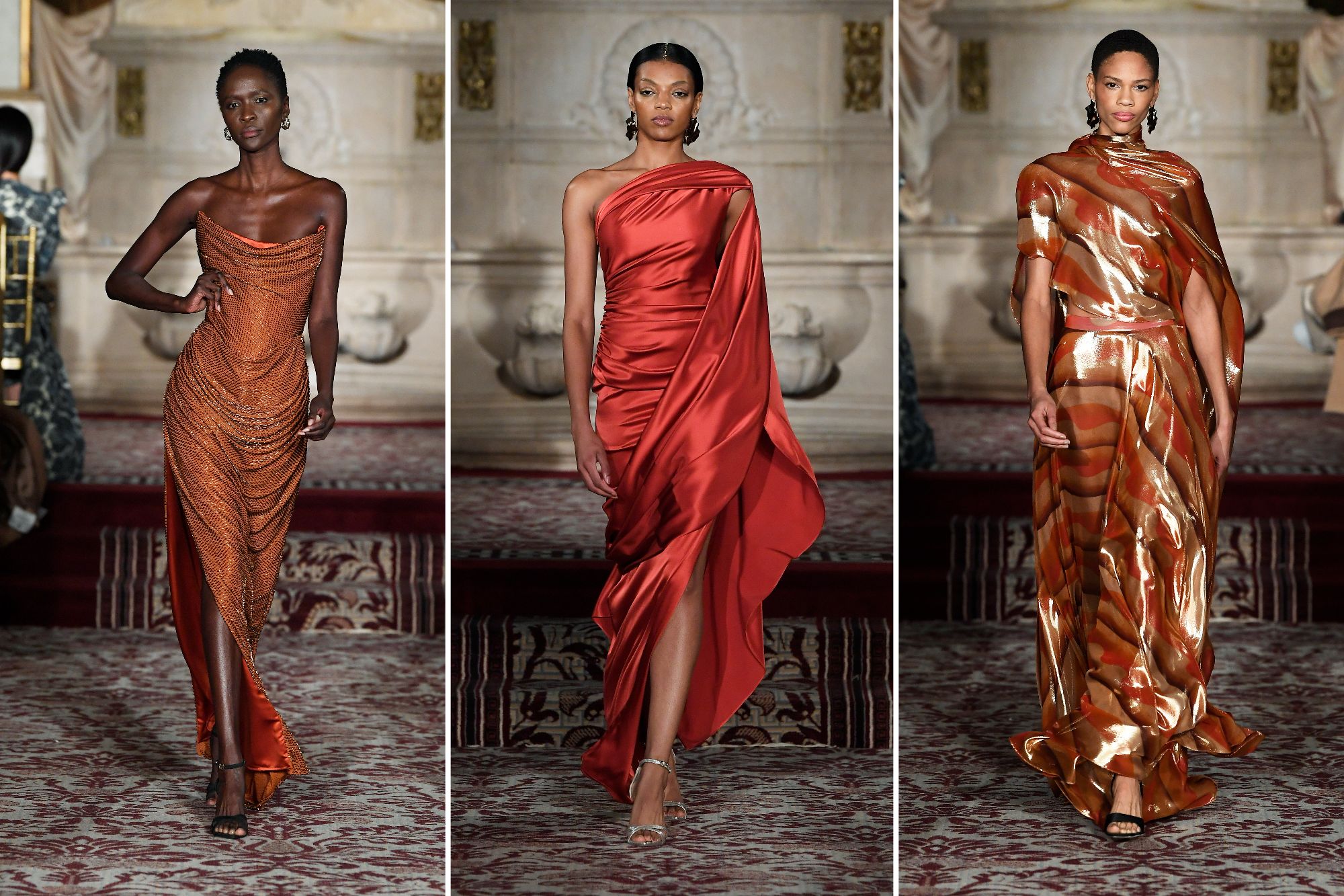 Three looks from Siriano's collection. On the far left, an orange corset draped gown; in the center, a red, one-shoulder draped dress; and on the right, an orange patterned dress.