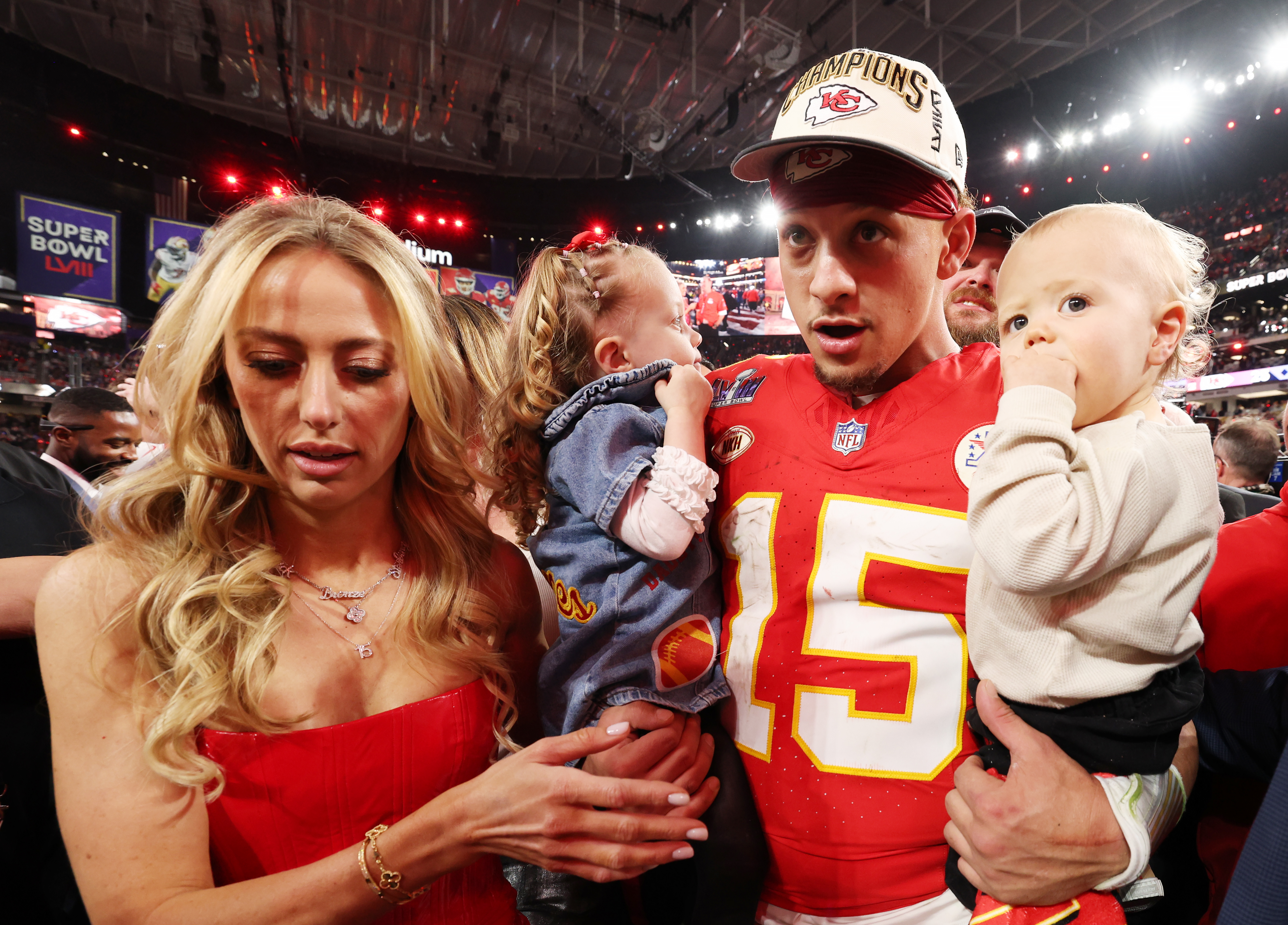 Patrick Mahomes holding his children with his wife Brittany by his side after winning Super Bowl LVIII against SF 49ers.